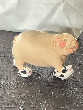 Piggie lovers delightful paper mache pig wearing cow slippers.